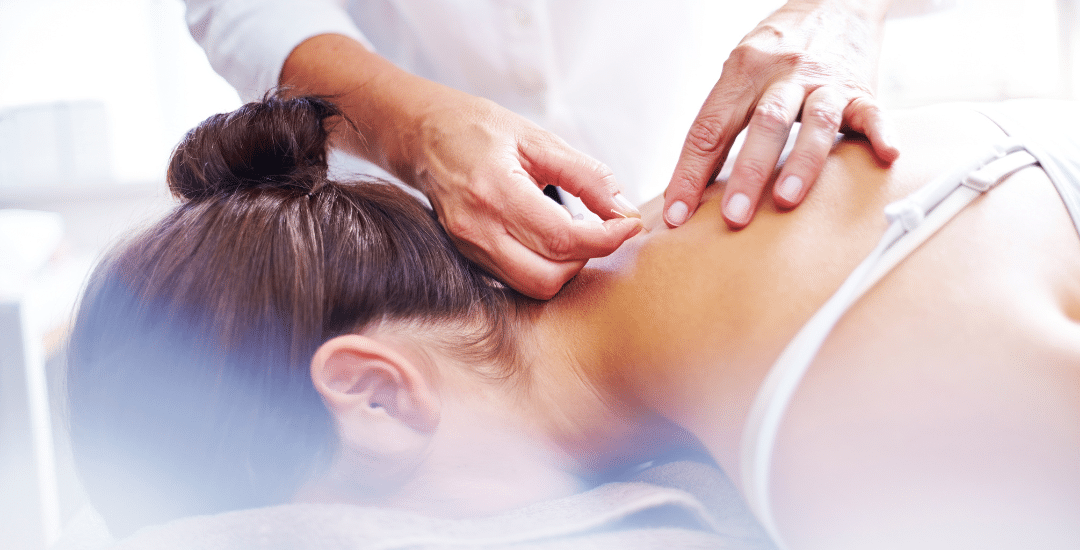 A woman receiving dry needling treatment for TMJ pain, with a focus on the targeted area and a professional performing the procedure.