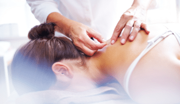 A woman receiving dry needling treatment for TMJ pain, with a focus on the targeted area and a professional performing the procedure.