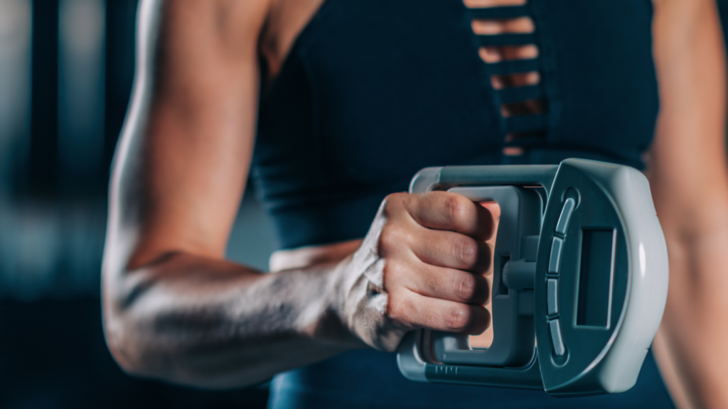 A woman with toned arms showcasing her muscles while performing a Dynamometer Hand Grip Strength Test, emphasizing her grip strength.